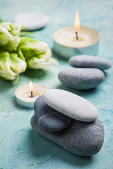 Fototapeta na wymiar Stones SPA treatment composition with lit candles