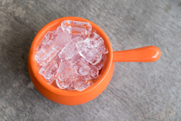 Ice in orange cup