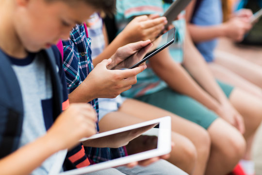 close up of elementary students with tablet pc