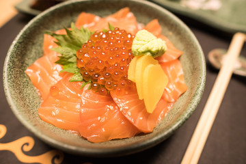 Japanese rice paste with salmon, salmon's roe and wasabi in a bowl with warm fall color , soft focus.