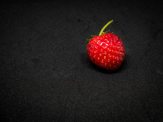 Closeup fresh strawberries on black background.