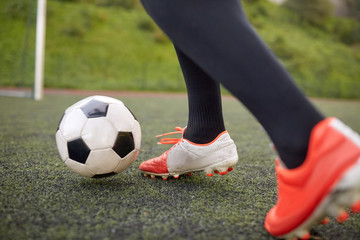 soccer player playing with ball on football field