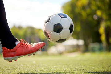 soccer player playing with ball on football field