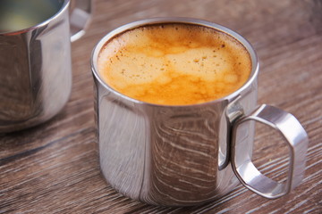 Fresh brewed coffee in a metal cup