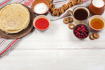 Russian pancake blini on white wooden background