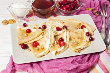 Russian pancake blini on white wooden background