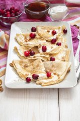 Russian pancake blini on white wooden background