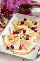 Russian pancake blini on white wooden background