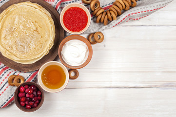 Russian pancake blini on white wooden background