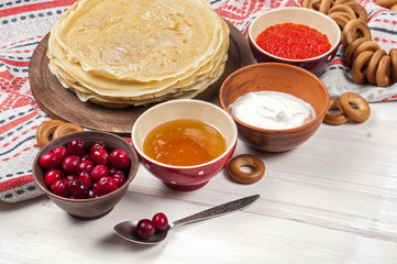 Russian pancake blini on white wooden background