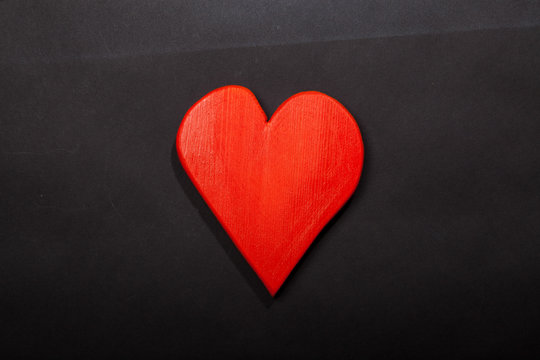 Holidays gift and heart on a black background. Valentines day