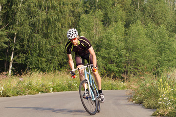 Fototapeta premium cyclist trains, young man in a sports bike. 