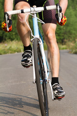 Naklejka premium cyclist trains, young man in a sports bike. 