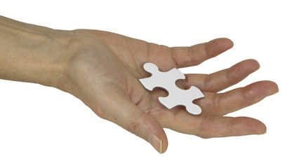 The Missing Piece of the Jigsaw - Female hand holding a piece of jigsaw isolated on a white background 