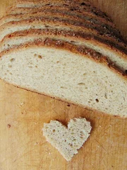 Foto auf Acrylglas Heart shaped piece of bread in front of full bread © melih2810