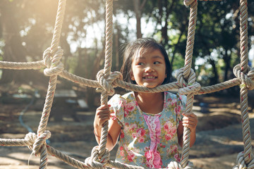 Girl Playing climbing rope nets