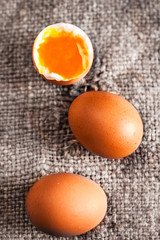 Hard boiled eggs with orange yolk in rustic style  on wooden bac