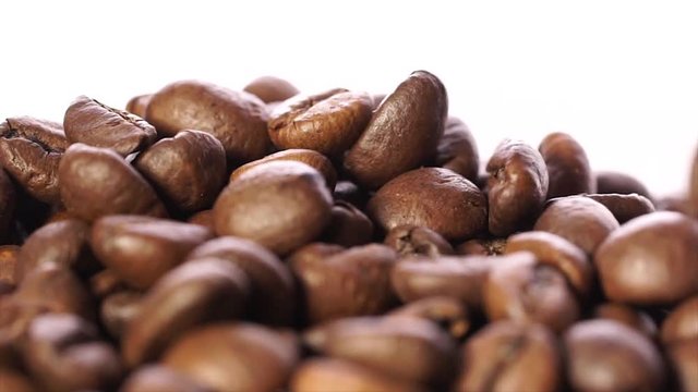 grain roasted coffee on a white background. Slow motion
