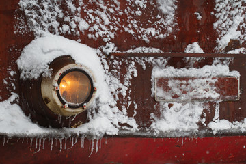 locomotive train detail with headlights covered in snow