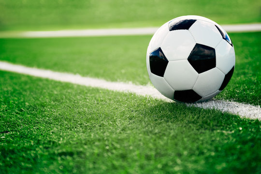 Fototapeta Soccer ball on soccer field
