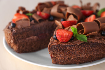 Delicious chocolate cake with strawberry on plate