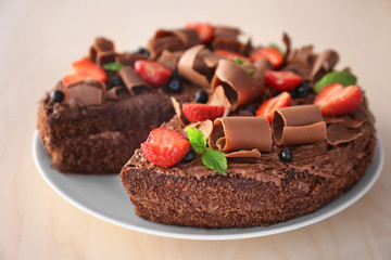 Delicious chocolate cake with strawberry on plate