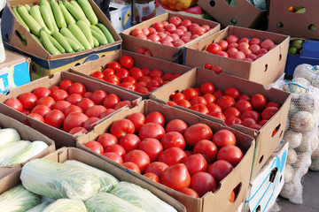 Fresh vegetables in cardboard boxes on market