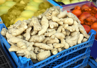 Plastic crate with ginger on market, closeup