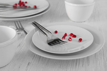 Cutlery set with plates on white wooden table