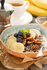 Obraz na płótnie Canvas Quinoa porridge with banana, blueberry and pecan nuts