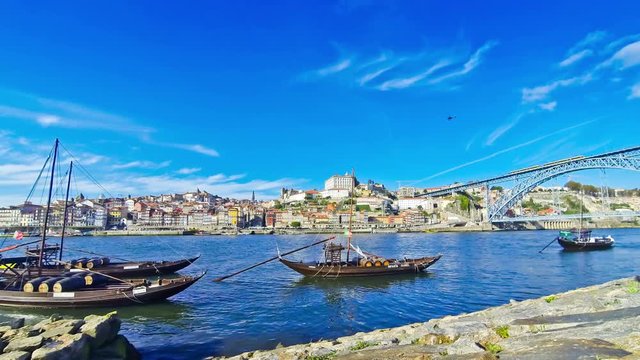 Traditional Portuguese boats on Douro river, City of Porto, Portugal. Time Lapse. 4K UltraHD