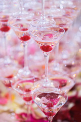 a pyramid of glasses with champagne