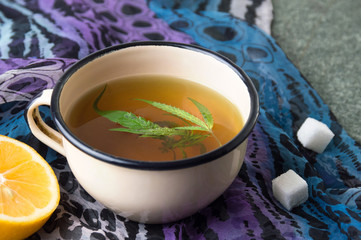 Cannabis herbal tea on stone table