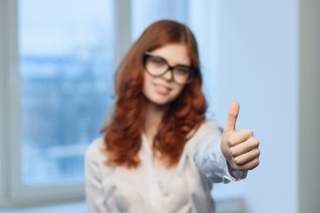 woman showing thumbs up, positive feedback