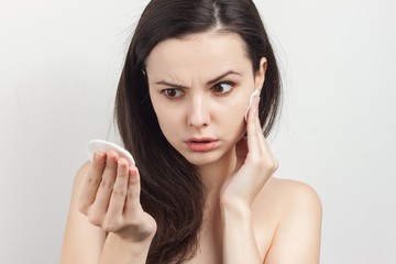 woman looking at a cotton ball