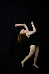 Girl dancer jumping and dancing on a black background. Studio sh © AS Photo Family
