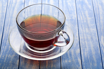 glass cup of tea on a wooden background