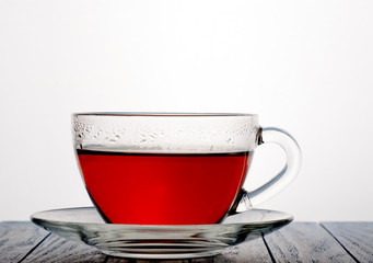 glass cup of tea on a wooden background