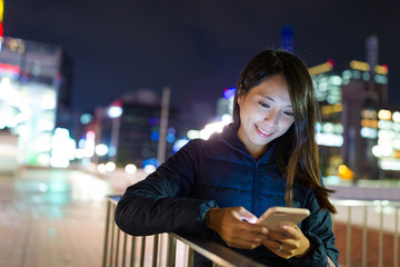 Woman use of mobile phone at night