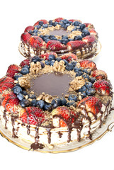 Chocolate cake decorated with glaze, strawberries and blueberrie