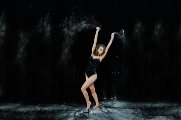 Girl dancer jumping and dancing in the white dust with flour on © AS Photo Family