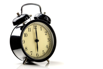 black vintage alarm clock isolated on white background show time