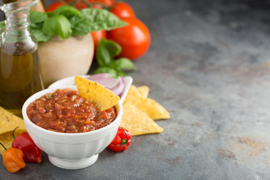 Homemade spicy tomato salsa with vegetables and olive oil