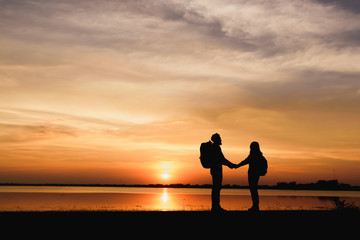 Fototapeta na wymiar Silhouette couple over sunset background