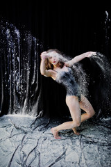 Girl dancer jumping and dancing in the white dust with flour on © AS Photo Family