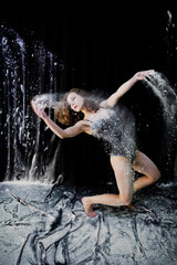 Girl dancer jumping and dancing in the white dust with flour on © AS Photo Family