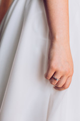 Wedding. Bridesmaid preparing bride for the wedding day. Bridesmaid helps fasten a wedding dress the bride before the ceremony. Luxury bridal dress close up. Best wedding morning. Wedding concept