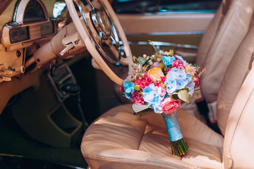 Wedding flowers colors bouquet with peones and hydrangea in retro car