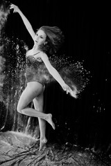 Girl dancer jumping and dancing in the white dust with flour on © AS Photo Family