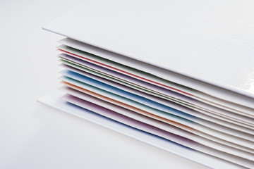 Closeup folder with colored documents on white background